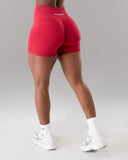 Red athletic shorts worn by a person on a gray background